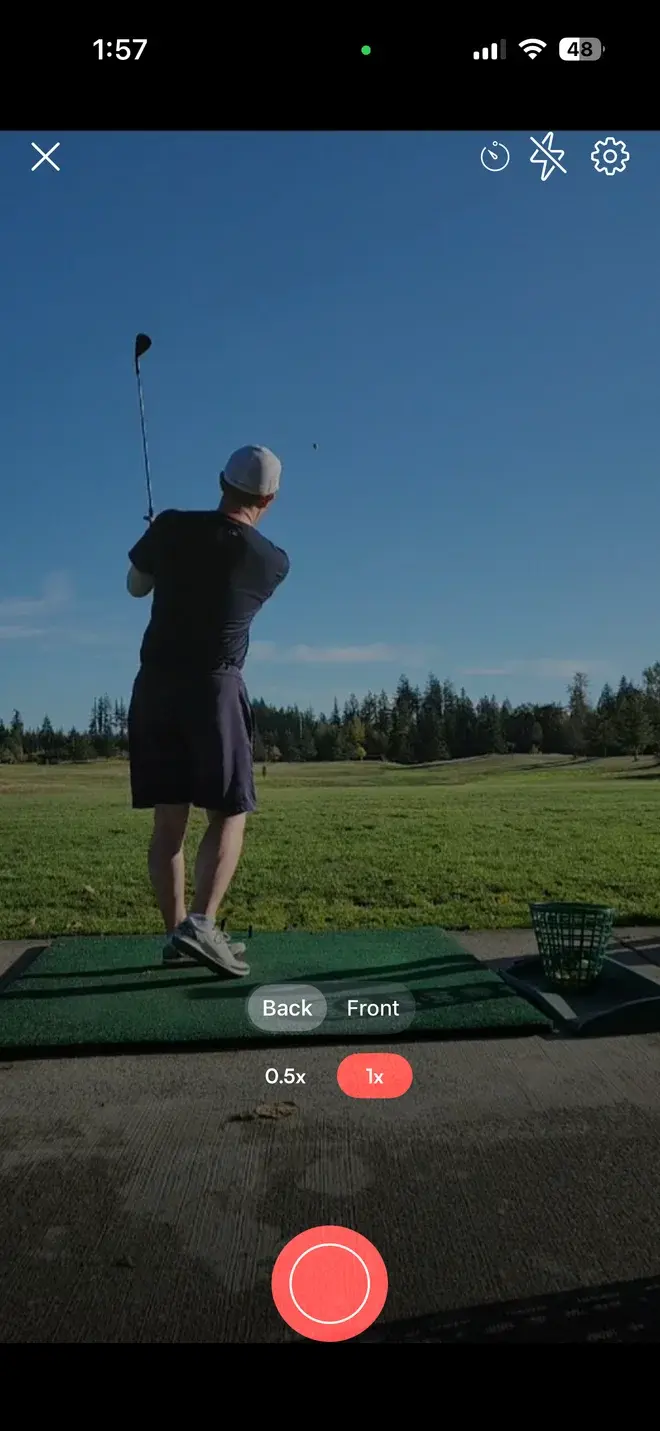 Skillest app camera capturing a golf swing, with record button, zoom and camera controls